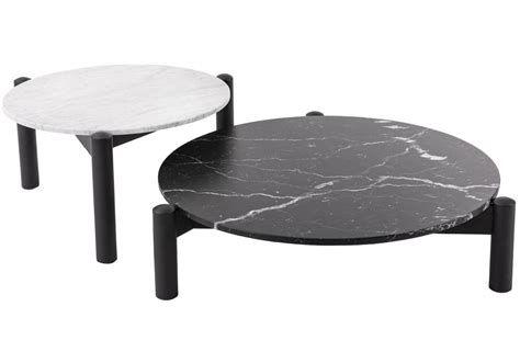 535 table à plateau interchangeable The structure of the base of the Table à plateau interchangeable is made up of three circular section legs in black stained ash wood, joined by three crosspieces on which the table top, in extra-white glass or Marquinia or Carrara marble, is placed